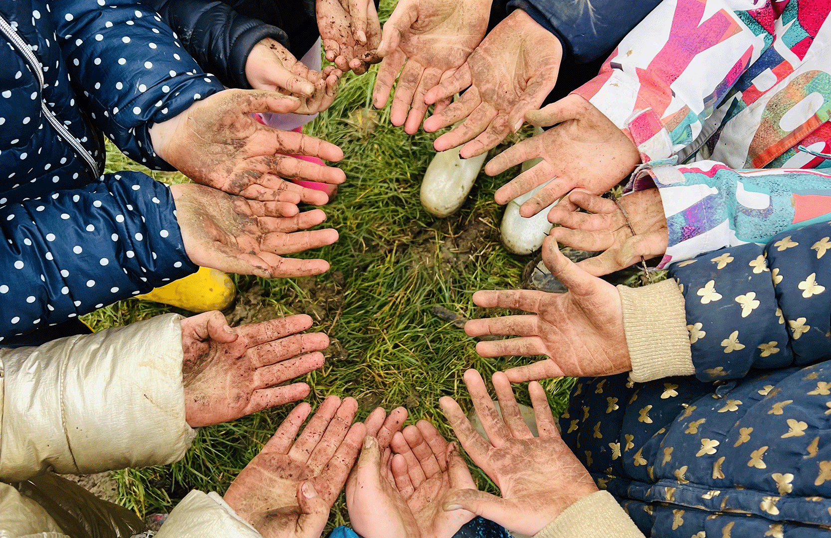 The children gathered with their hands full of dirt.